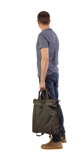 istock Back view of a man with a green bag. 1128906341