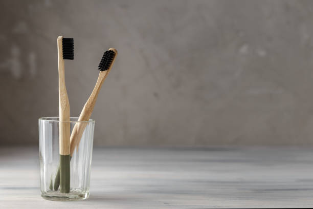 istock Two eco friendly bamboo tooth brushes in a glass 1128906358