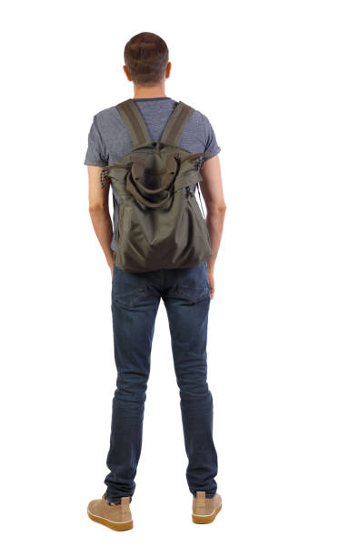istock Back view of a man with a green bag. 1128907113
