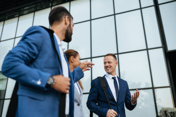 istock Three business colleagues having discussion while walking outdoors 1128907273