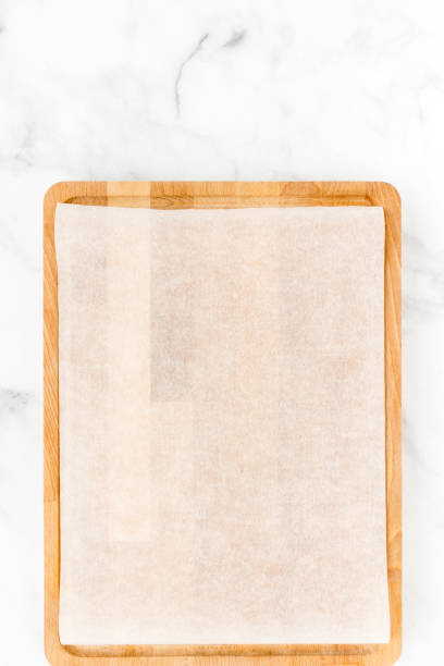 istock Wooden Cutting Board with White Parchment as Food Background 1128908029