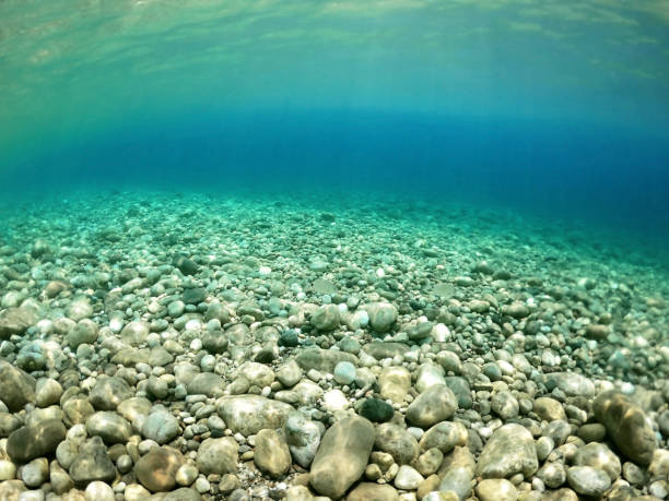 istock Transparent sea water at pebble beach. Under water. 1128908874