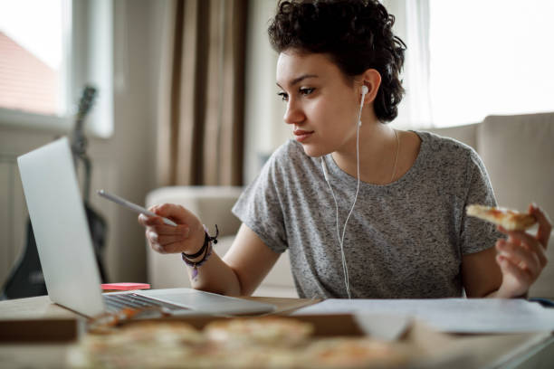 istock Female student studying and listening to music 1128908933