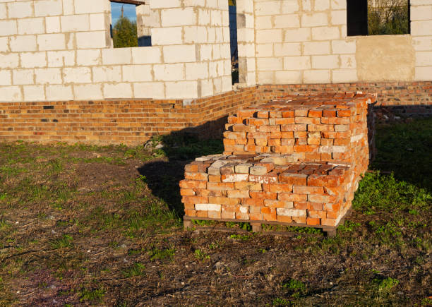 istock Pile of old red bricks on the pallet on the sunset 1128909316