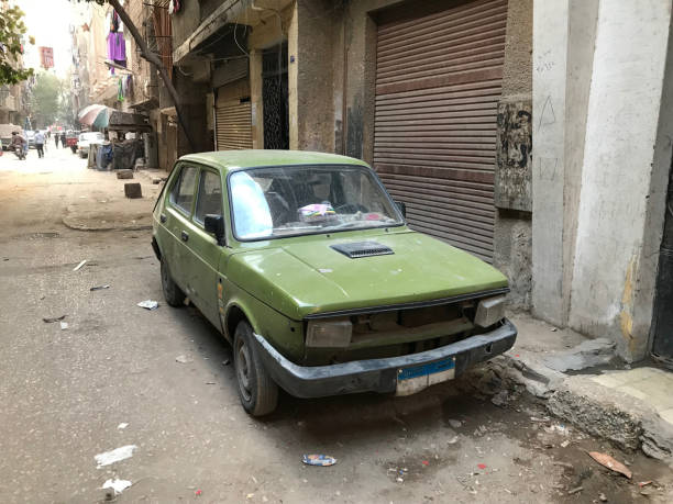 istock LIFE IN EGYPT - A VERY OLD CAR COVERED IN DUST 1128910616