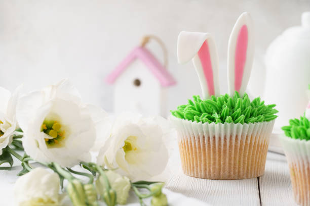 istock Easter cupcake decorated with bunny ears for dessert and flowers 1128912204