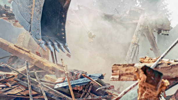 istock Demolition excavator clearing debris at demolition site 1128913330