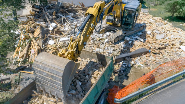 istock Digger placing construction waste of demolished building onto a truck 1128913421