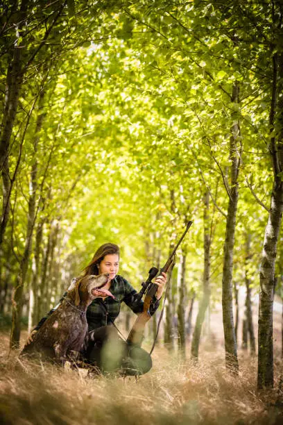 Autumn hunting season. Hunting. Outdoor sports. Woman hunter in the woods