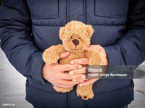 Man With A Teddy Bear In His Hands Grief Stock Photo - Download Image Now - Death, Child, Childhood