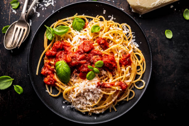 istock delicious appetizing classic spaghetti pasta with tomato sauce, parmesan cheese and fresh basil, top view 1128915923