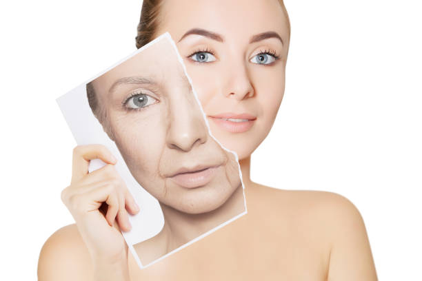 closeup portrait of young woman face holding portrait with old wrinkled face beauty concept. skin treatment, anti age therapy antiaging stock pictures, royalty-free photos & images