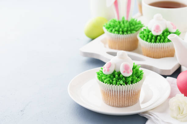 istock Easter background with bunny cupcakes and tea for breakfast. 1128917741