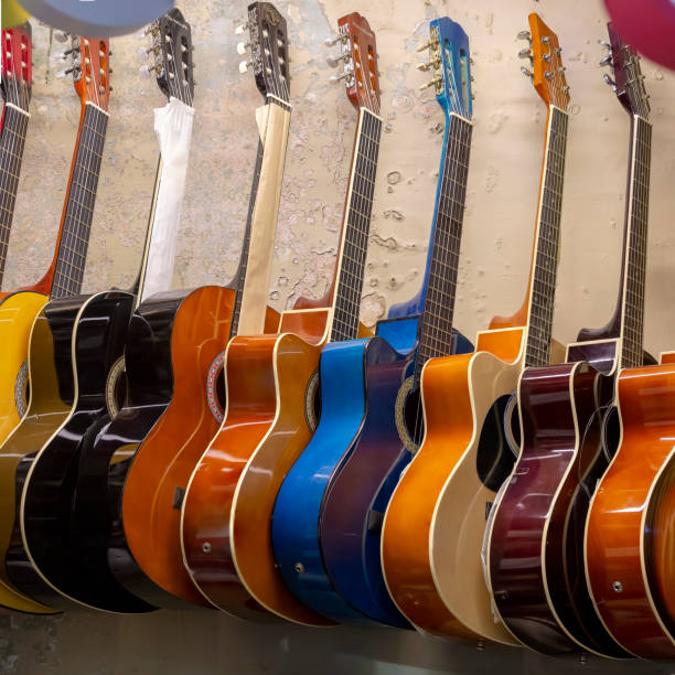 istock Guitars hanging in a row on the wall 1128917791