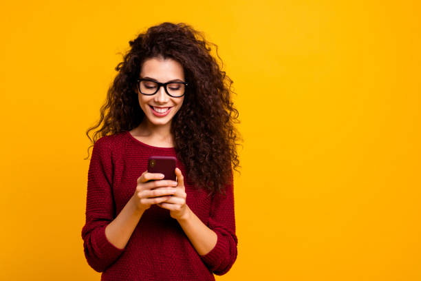 Portrait of her she nice lovely attractive pretty cheerful cheery wavy-haired lady holding in hands cell playing game free time isolated over bright vivid shine orange background Portrait of her she nice lovely attractive pretty cheerful cheery wavy-haired lady holding in hands cell playing game free time isolated over bright vivid shine orange background Student app stock pictures, royalty-free photos & images