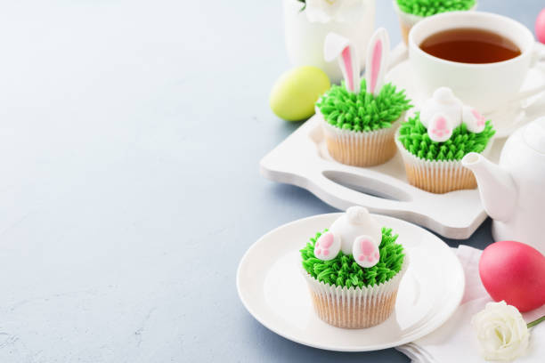 istock Easter bunny butt and ears cupcakes and tea. 1128918116