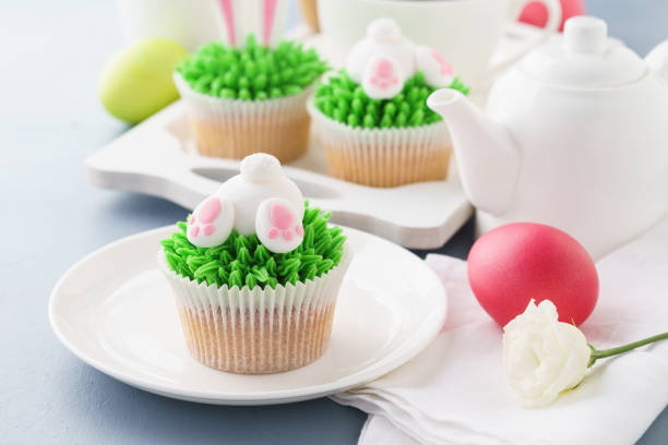 istock Easter bunny butt and ears cupcakes and tea. 1128918666