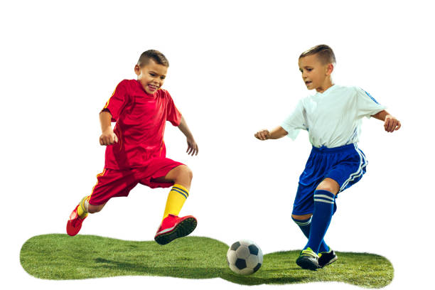 istock Young boys kicks the soccer ball 1128919523