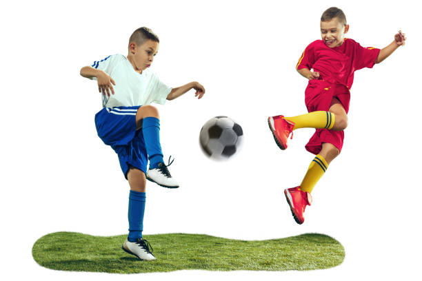 istock Young boys kicks the soccer ball 1128919532