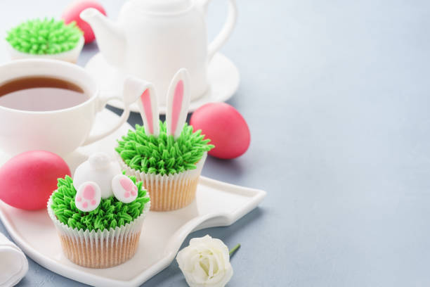 istock Easter background with bunny cupcakes and tea for breakfast. 1128919562