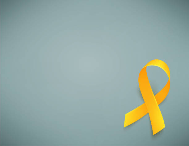 istock Background with realistic yellow ribbon. World childhood cancer awareness symbol, vector illustration. 1128919589