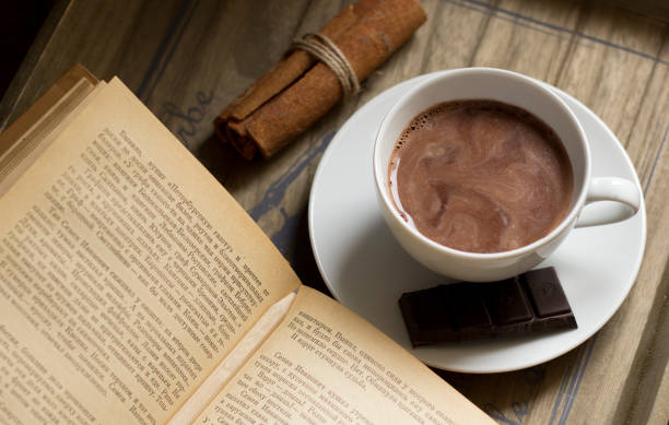 istock Cocoa drink, book,  cinnamon, chocolate and cookies 1128920449
