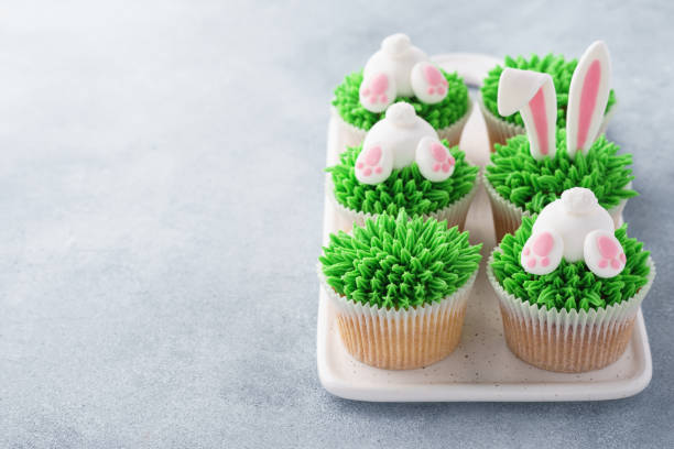 istock Set of Easter cupcakes for kids. Grass, bunny ears and butt. 1128920844