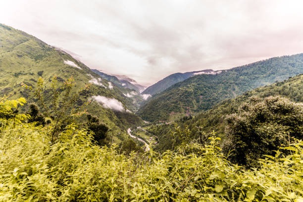 istock Tropical mountain range view. Timelapse Of Moving Clouds And Fog over Himalayan mountain range in Sainj 1128920944