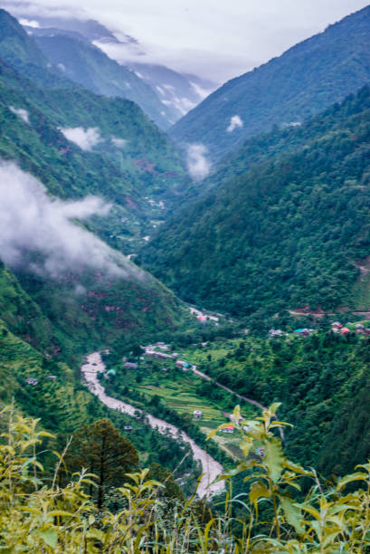 istock Tropical mountain range view. Timelapse Of Moving Clouds And Fog over Himalayan mountain range in Sainj 1128920992