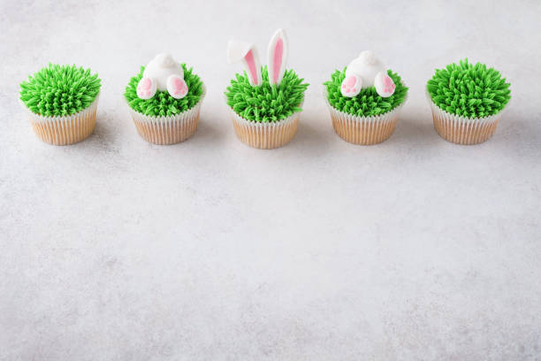 istock Easter cupcakes in a row. Decorated as bunny butt and ears 1128921162
