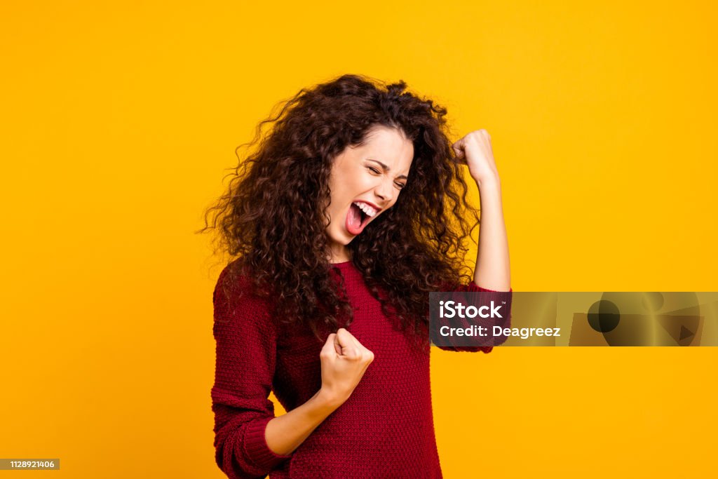 Close up photo amazing beautiful her she lady yelling voice raised fists eyes closed in delight emotional high spirits mood wearing red knitted sweater clothes outfit isolated yellow background Women Stock Photo