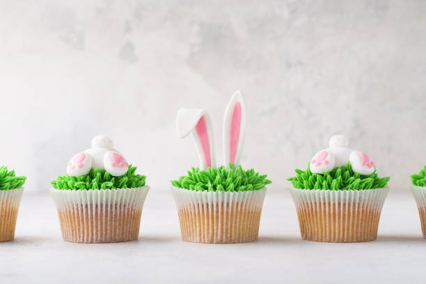 istock Homemade Easter cupcakes in a row. Funny dessert for children. 1128922297