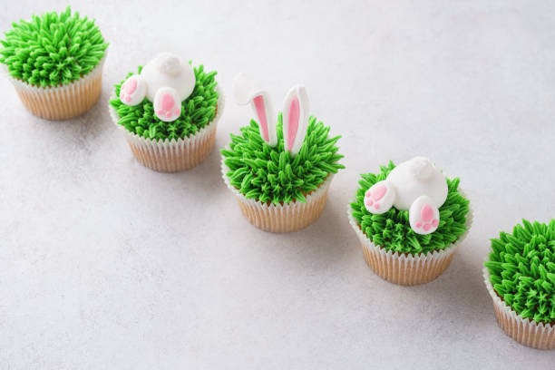 istock Easter cupcakes in a row. Decorated as bunny butt and ears 1128922558