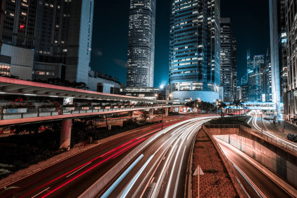istock Moving car with blur light through city at night 1128922874