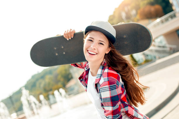 istock Young woman with skateboard outdoors active lifestyle 1128923355