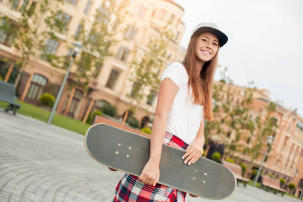 istock Young woman with skateboard outdoors active lifestyle 1128923462