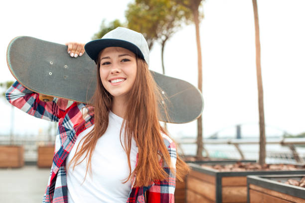istock Young woman with skateboard outdoors active lifestyle 1128923475