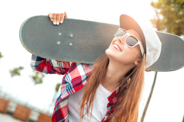istock Young woman with skateboard outdoors active lifestyle 1128923486