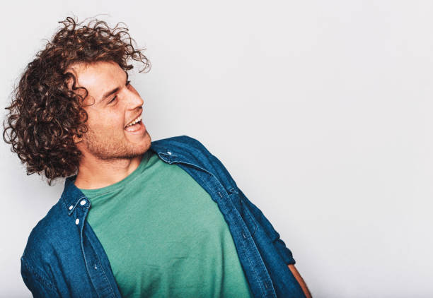 istock Cheerful positive smiling man, posing for social advertisement, isolated on white background, looking to blank copy space for your promotional information. People and emotions 1128924495