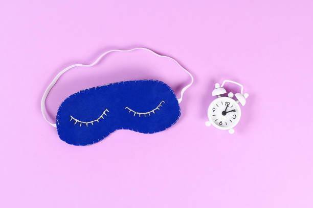 istock Diy blue felt sleep mask with white thread embroidered with closed eyes with eyelashes on gum 1128929200