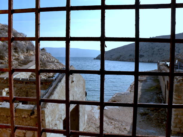 metal grid with square cells on the background of the sea and the horizon