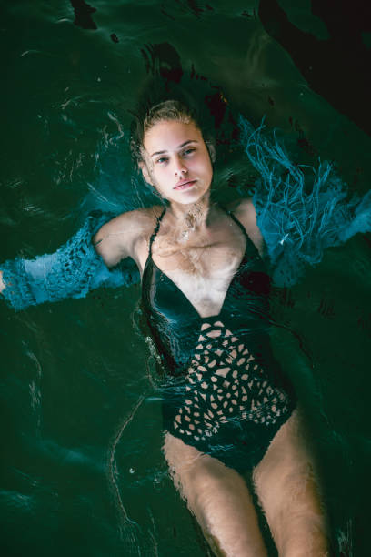 istock Adorable Female Posing While Swimming On Her Back 1128929912