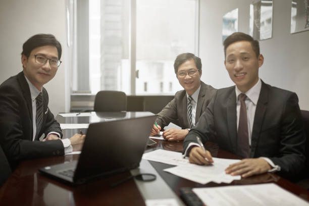 istock Confident businessmen sitting in board room 1128931033