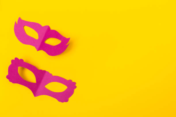 istock cut out colored paper figures for the holiday Mardi Gras, colour background 1128932464