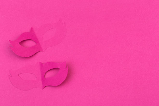 istock cut out colored paper figures for the holiday Mardi Gras, colour background 1128932466