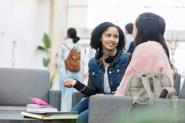 istock Teenage girls catch up before class 1128932847