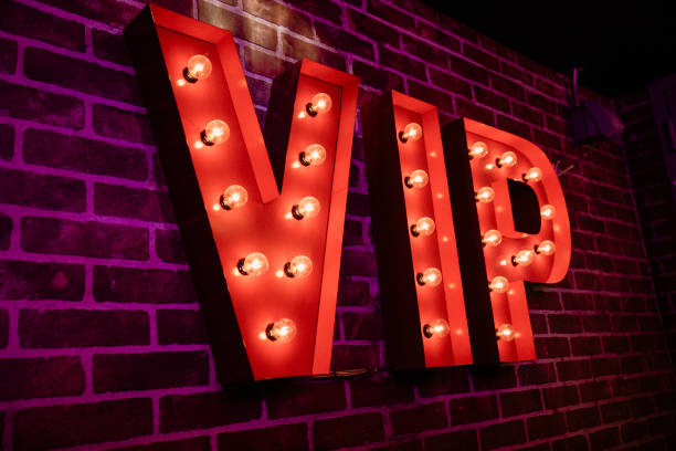 VIP Lightbulb Sign VIP red lightbulb sign on a brick wall in an indoor establishment. first class photos stock pictures, royalty-free photos & images