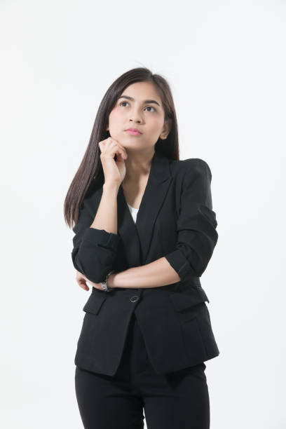 istock Thoughtful Young Businesswoman Standing Over White Background 1128934868