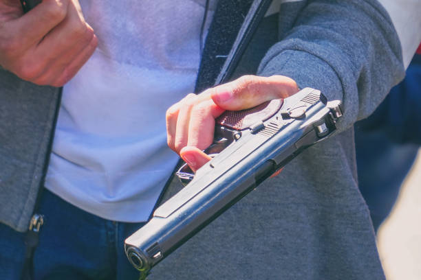 istock The gun in the man's hand 1128934929