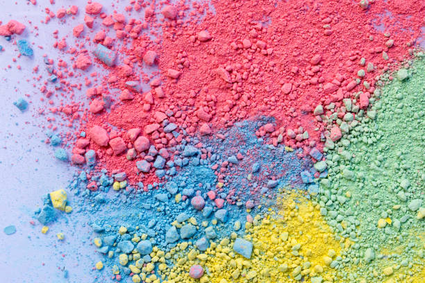 istock Colorful background of chalk powder. Multicolored dust particles splattered on white background. 1128935035